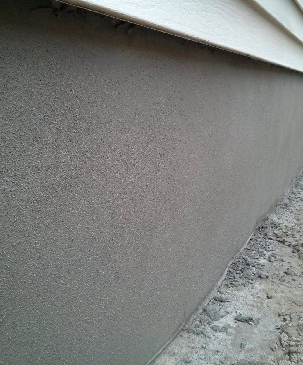 parging on a block foundation wall in South Dundas